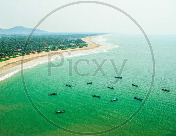 Aerial View Of Lone Fishing Boats on Sea Water With Beach From a Hill Top