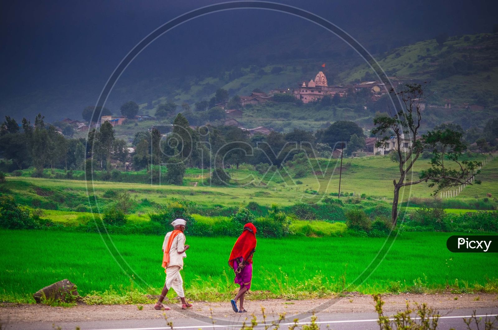 A Maharastrian Old Couple Walking Along The Road side