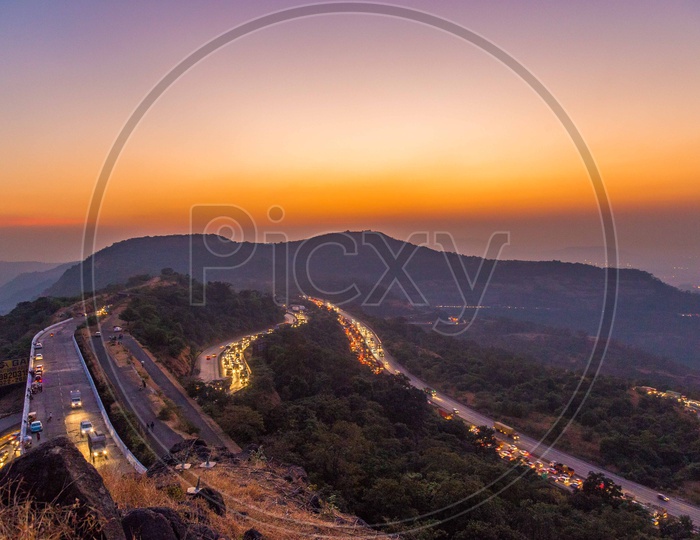 Vehicles On The Ghat Roads Laid On Western Ghats over  a Golden Hour Sky
