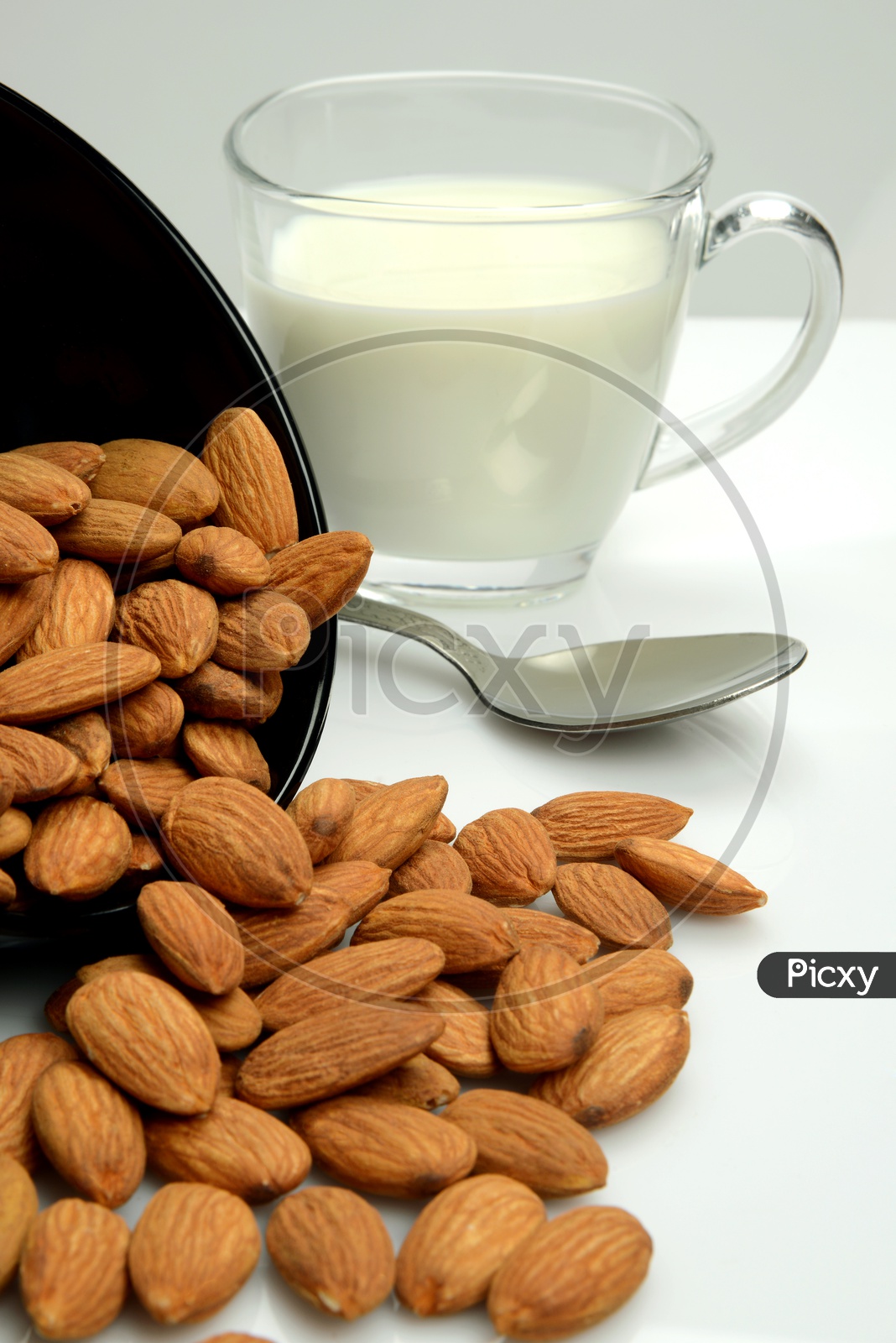 Healthy food, Dryfruit Almond Seeds in a bowl and a cup of fresh milk