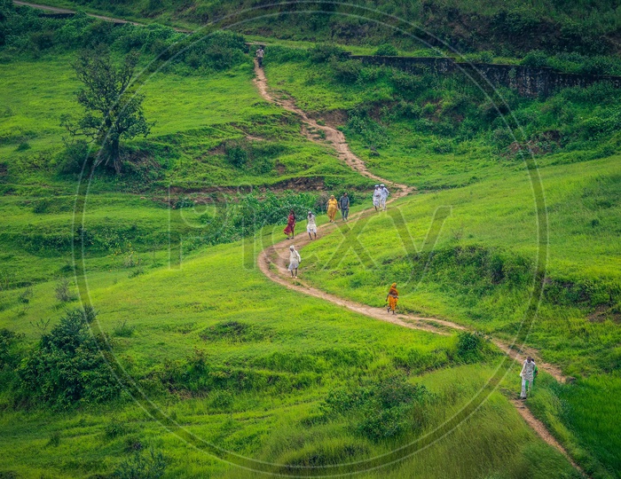 Villagers Walking Along The Pathways In Green Plateaus