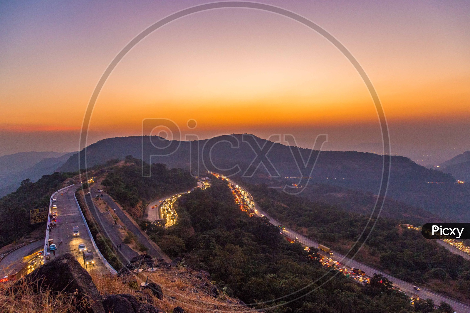 Vehicles On The Ghat Roads Laid On Western Ghats over  a Golden Hour Sky