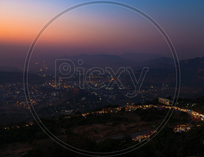 Aerial View Of City Scape With Luminous Lights from Houses from a Hill Top