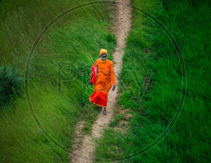 Indian Hindu Sadhhu Or Babas Walking Along The Pathways In Green Plateaus Of Western Ghats