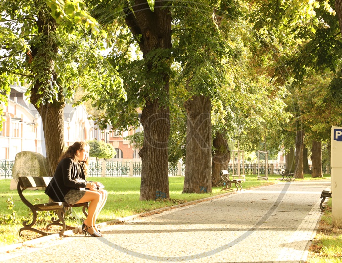 Women sitting on a pathway at autumn park