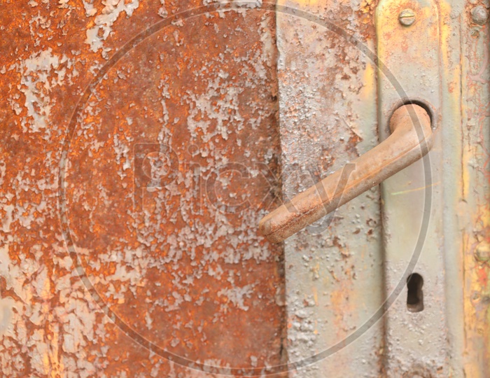 A rusted door with a handle