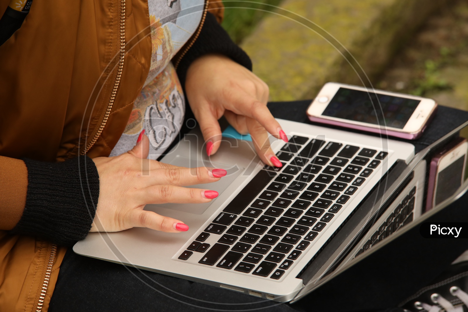 a woman Working Hands On Laptop(macbook and iPhone)
