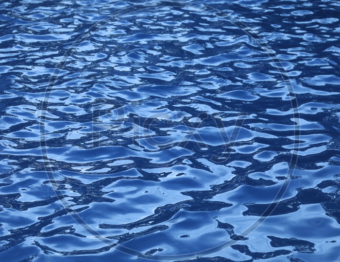 Texture Of Ripples on a  Water Surface With Luminous Blue Colour