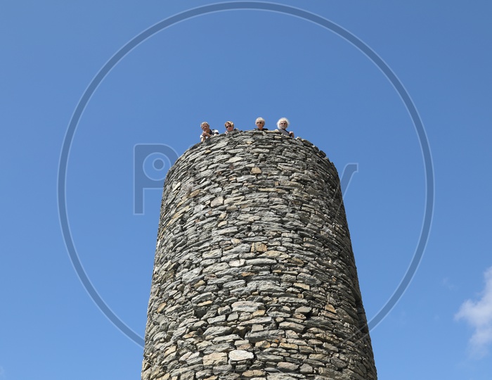 Visitors on top of a Stone Tower