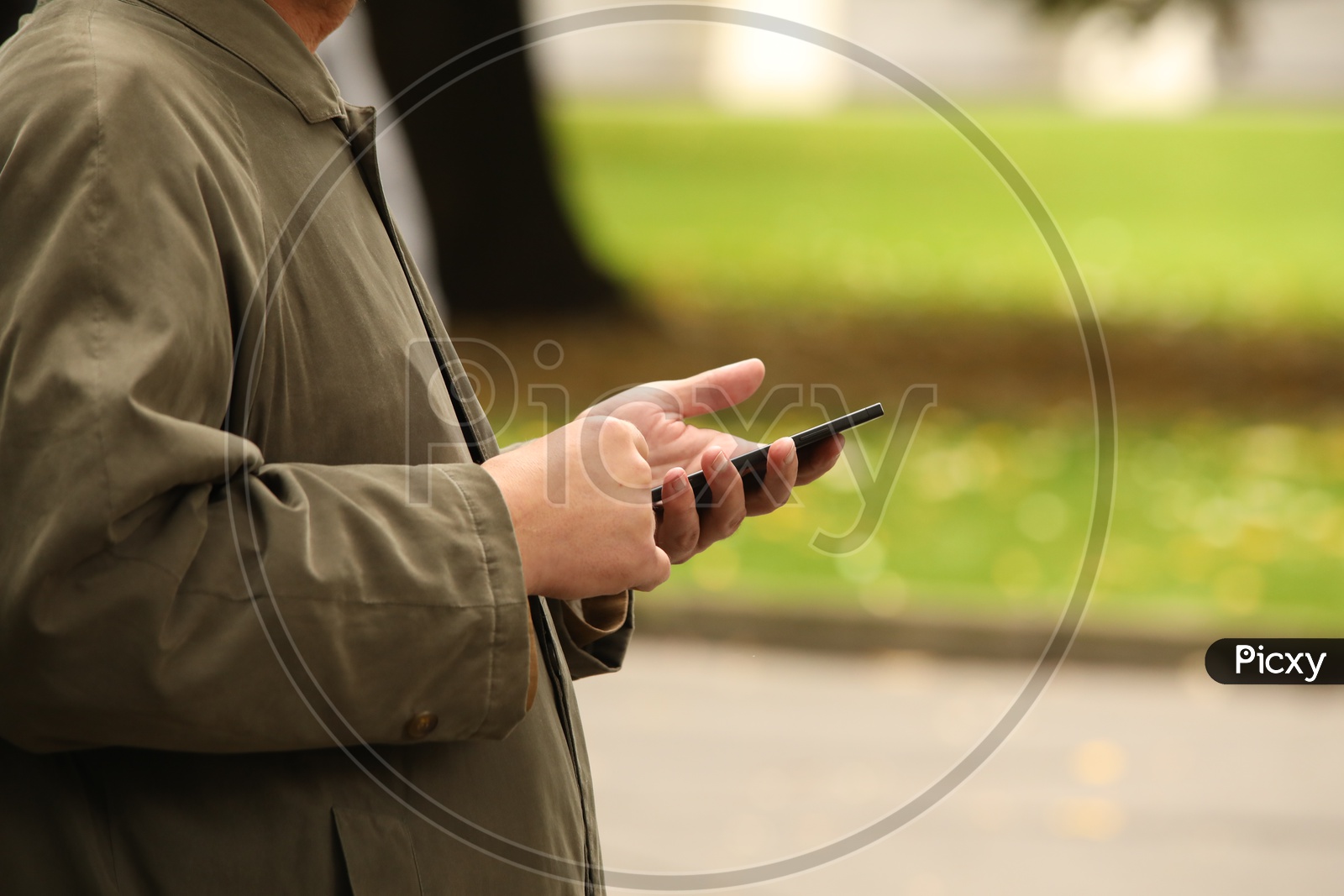 A Man Using Mobile in His Left hand Closeup Shot