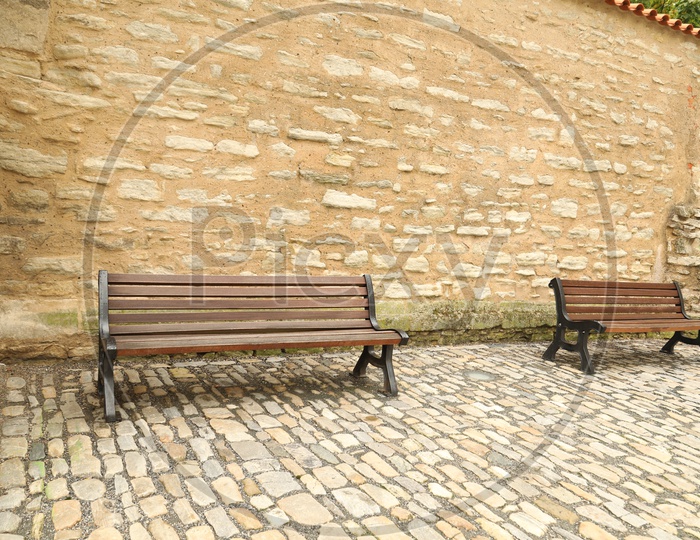 Benches alongside the old stoned wall