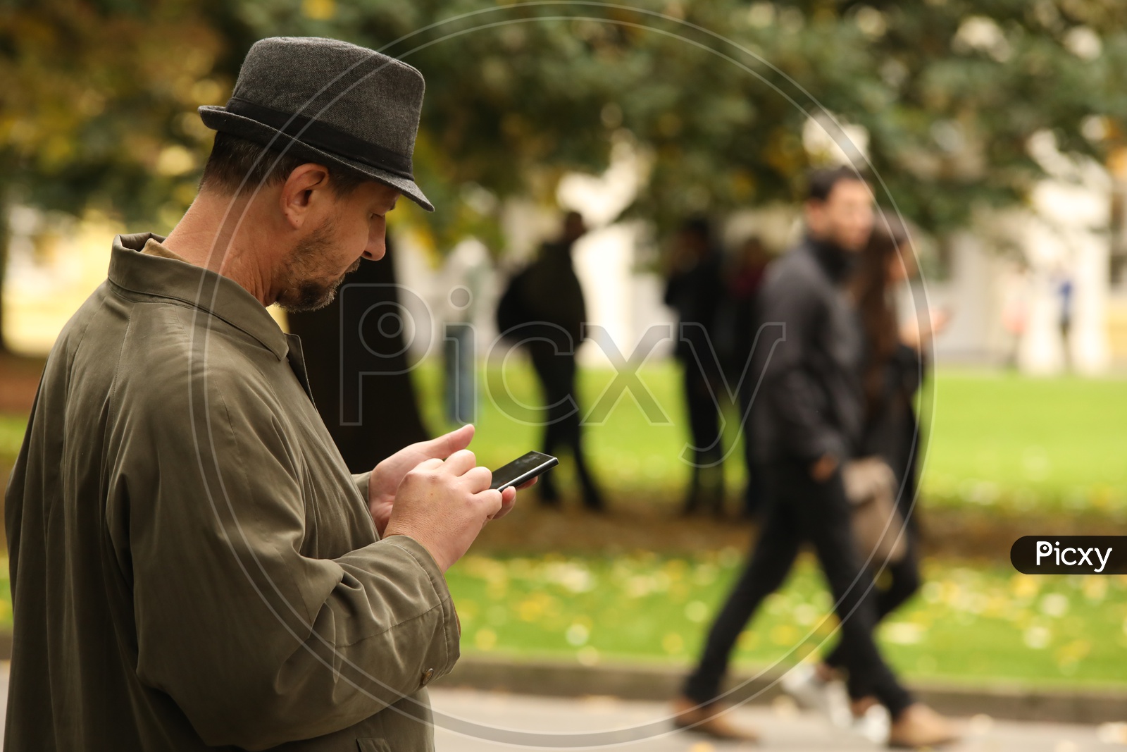 A Man Using Mobile in His Left hand