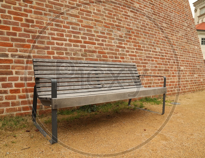 Bench alongside the old bricked wall
