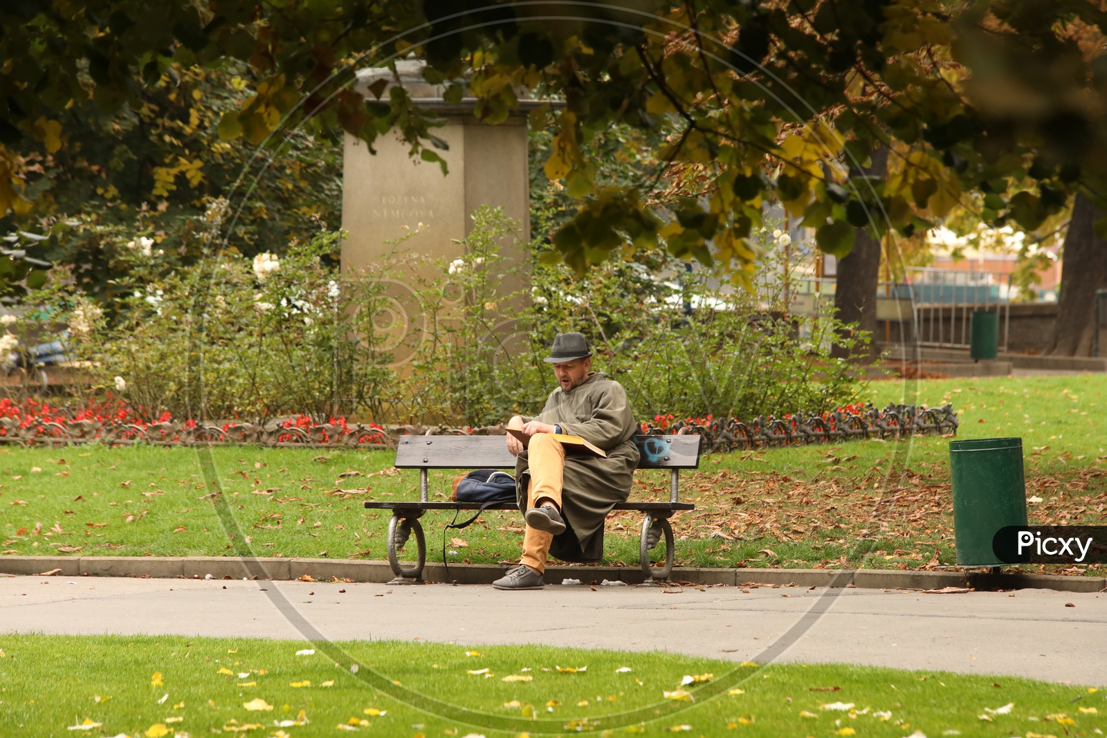 Man reading book in a park in Prague
