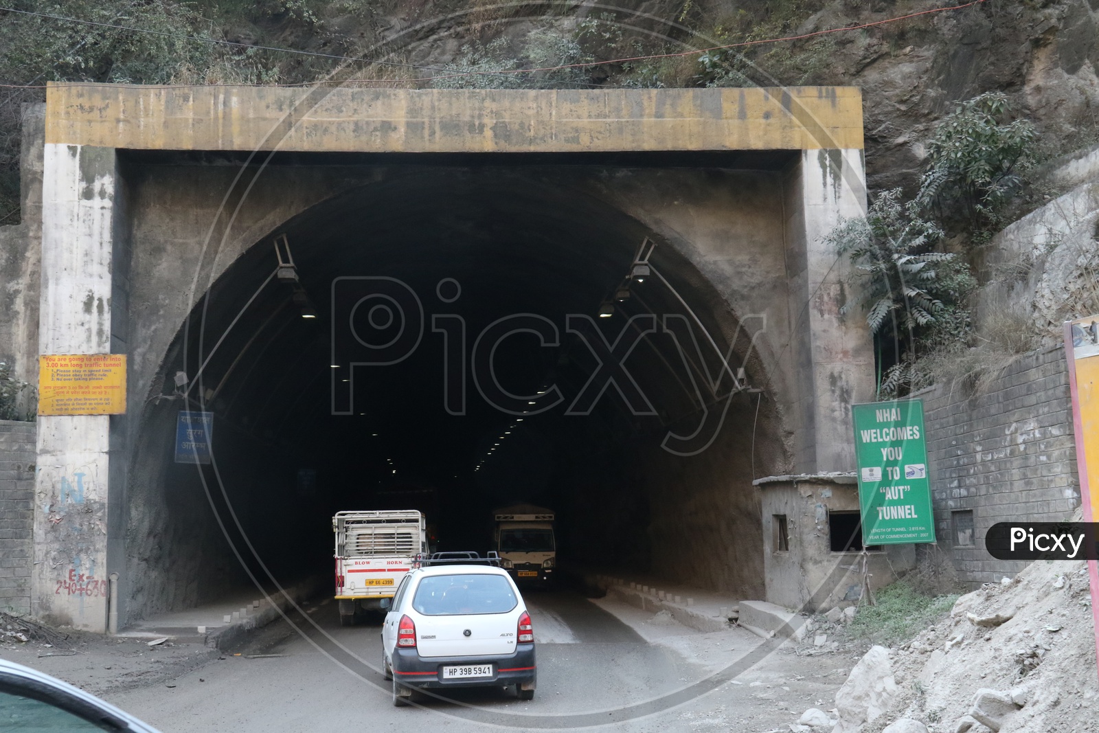 Moving cars in to tunnel in hilly area
