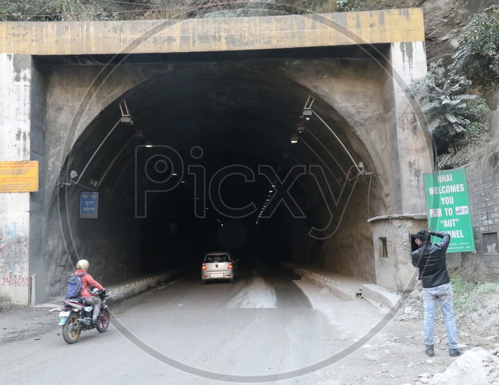 A man taking a picture of the tunnel in the hills, AUT Tunnel