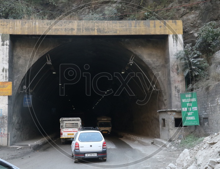 Moving cars in to tunnel in hilly area