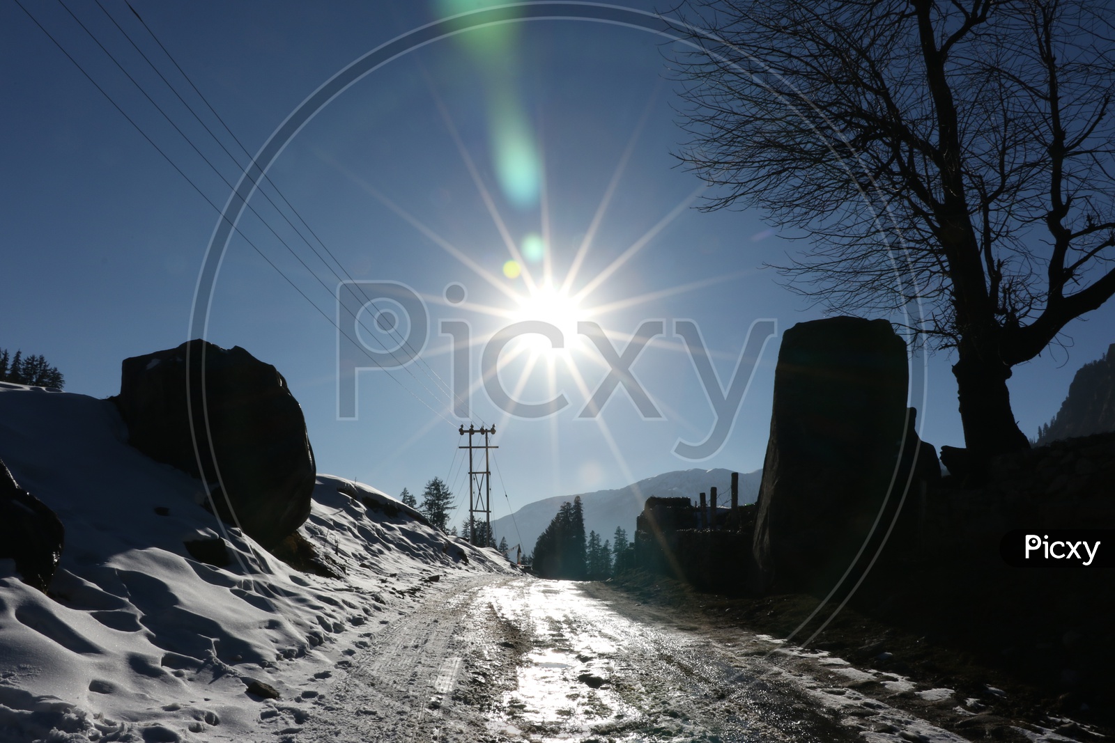 Bright sun and a road in the hills