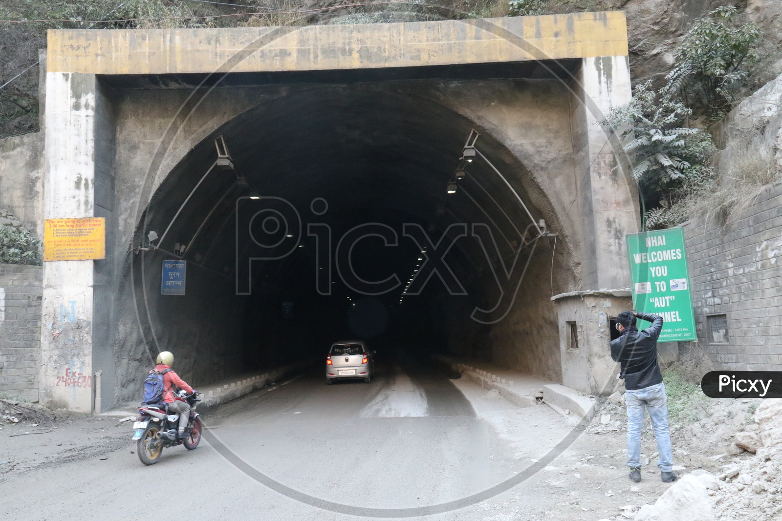 A man taking a picture of the tunnel in the hills, AUT Tunnel