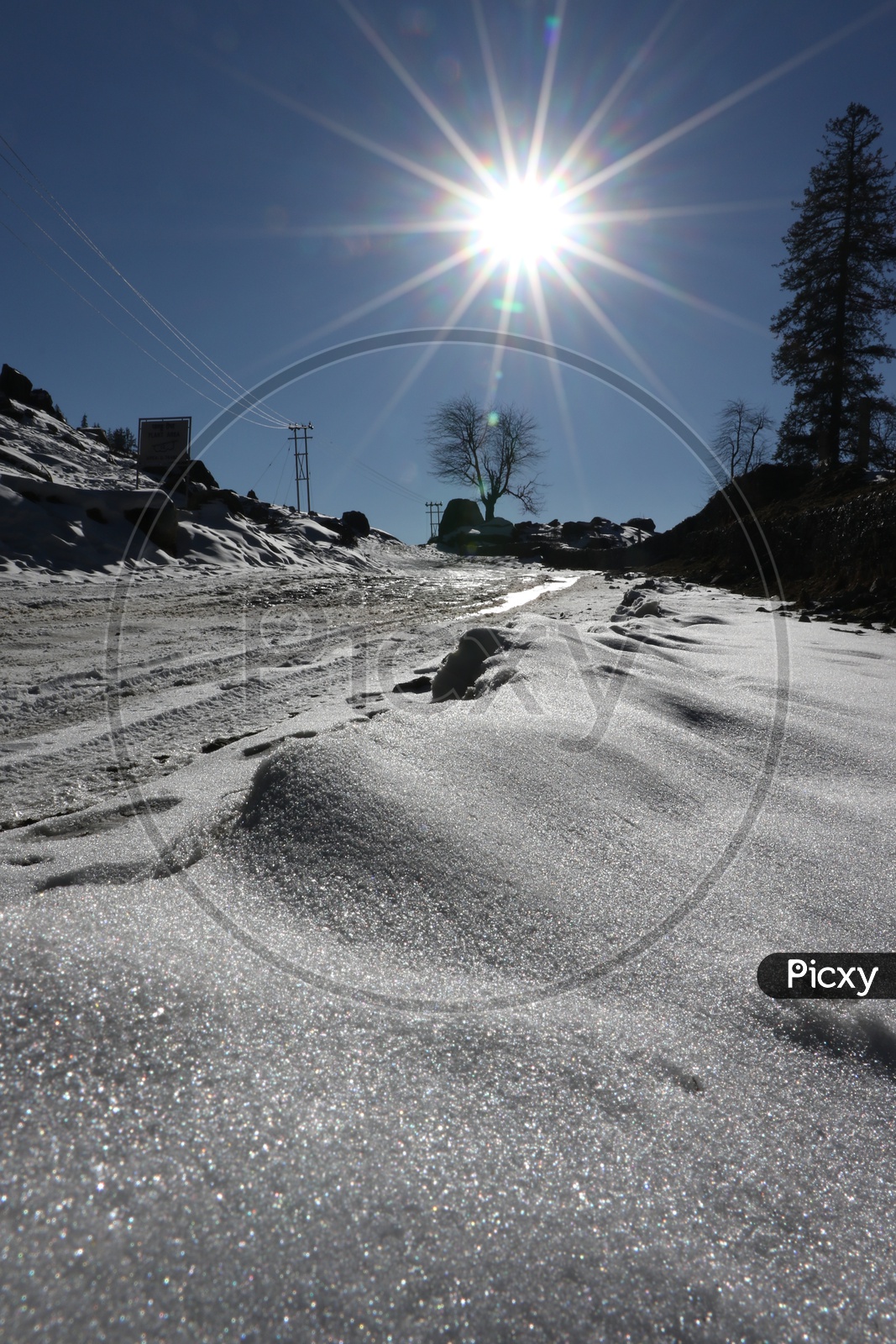 Glittering snow on the road with shining sun