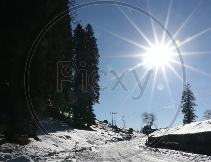Roads with full of snow and a bright sun