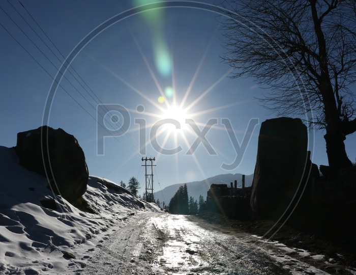 Bright sun and a road in the hills
