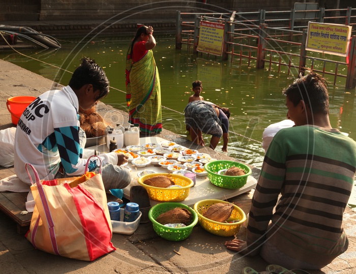 Devotees performing puja rituals at Ganga river in Varanasi