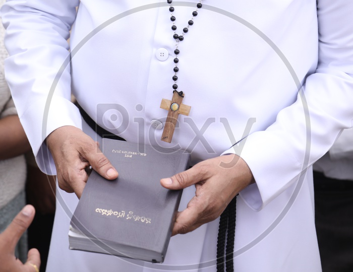A Church father holding the Bible