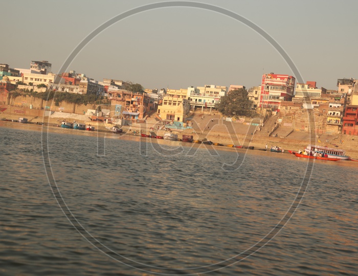 Long view of Varanasi Ghats with boats and visitors