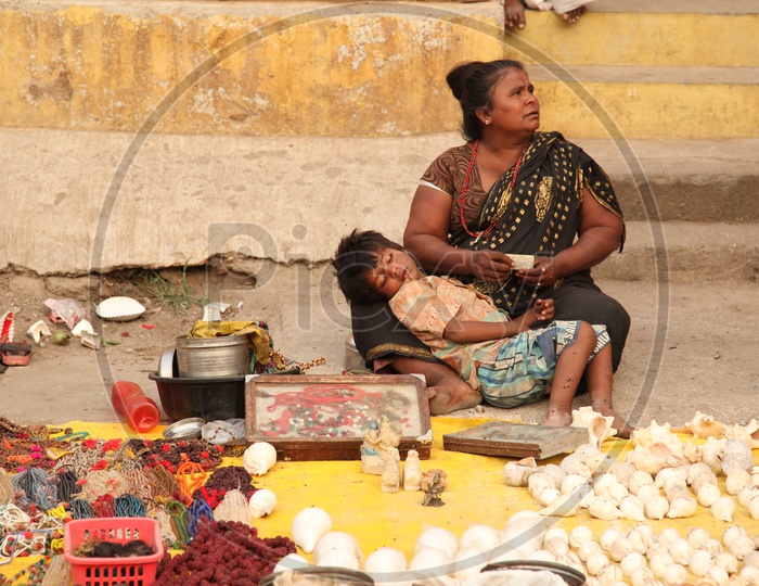 Street vendor selling sea shells and chains with beads in the streets of Varanasi