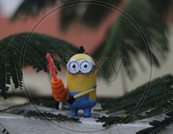Toy Minion on the terrace between the leaves