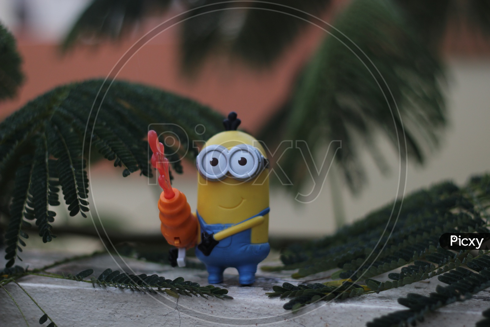 Toy Minion on the terrace between the leaves