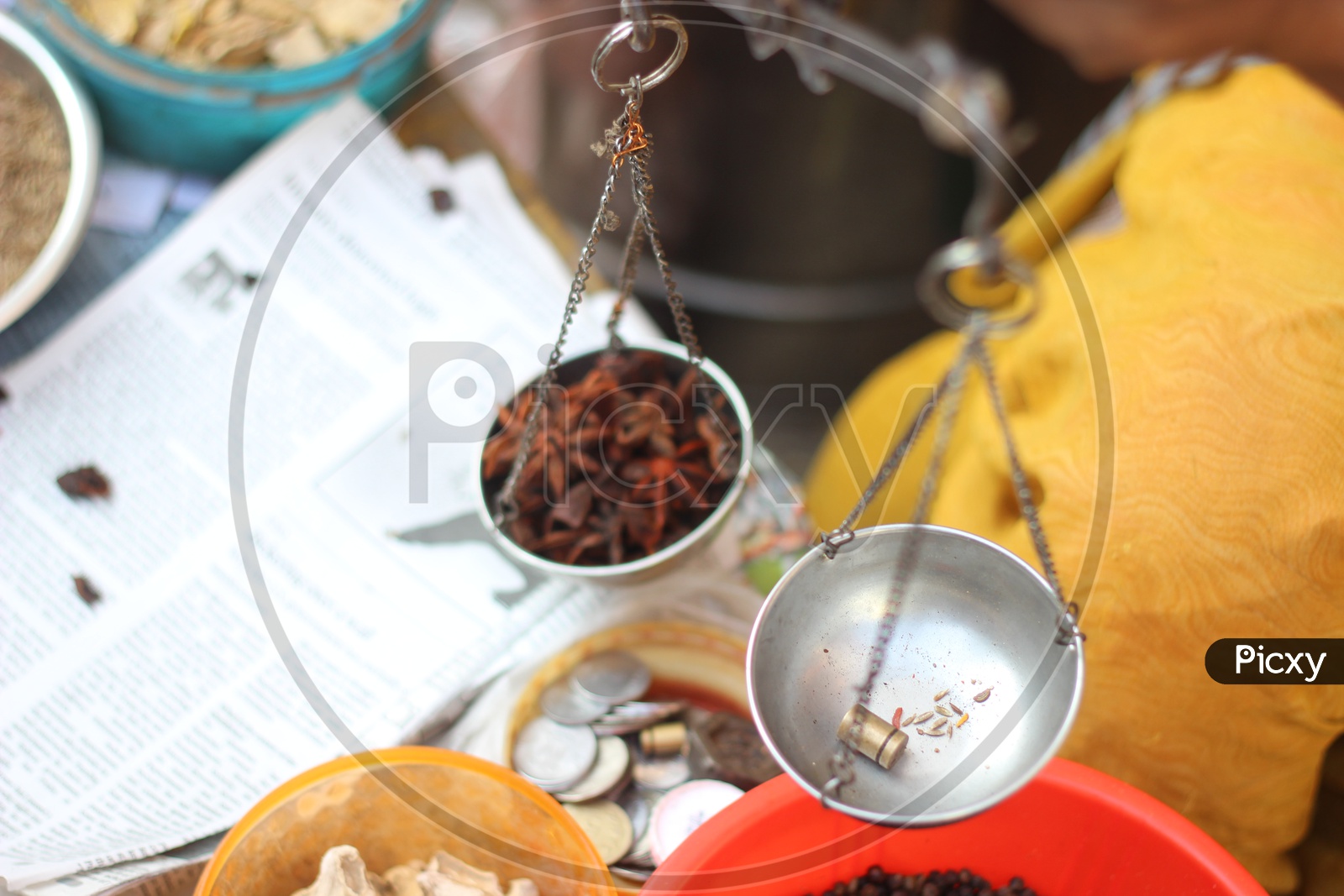 Star anise is weighed in a small weighing scale - Indian Spices