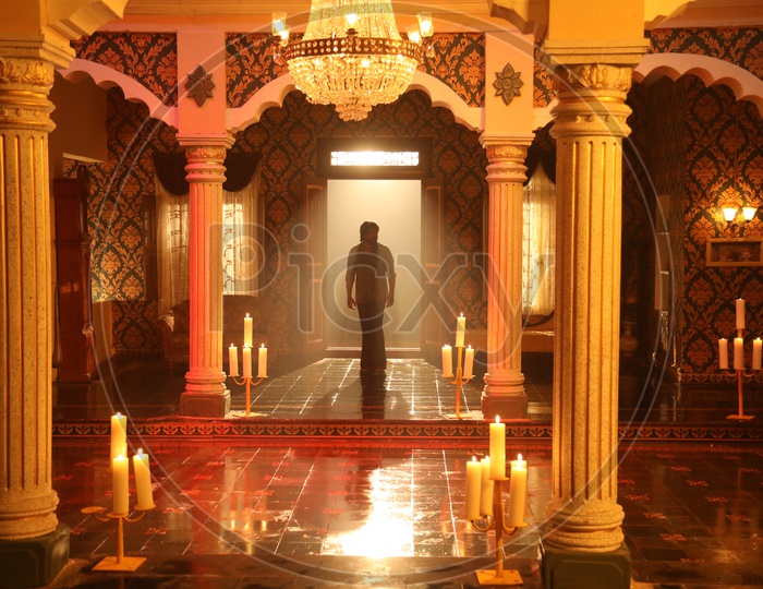Man at Royal Indian court set up with a Throne and chandelier