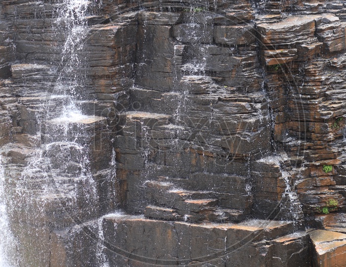 Water fall against rocks