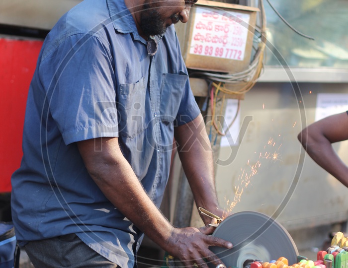 man sharpening knife In Vijayawada streets