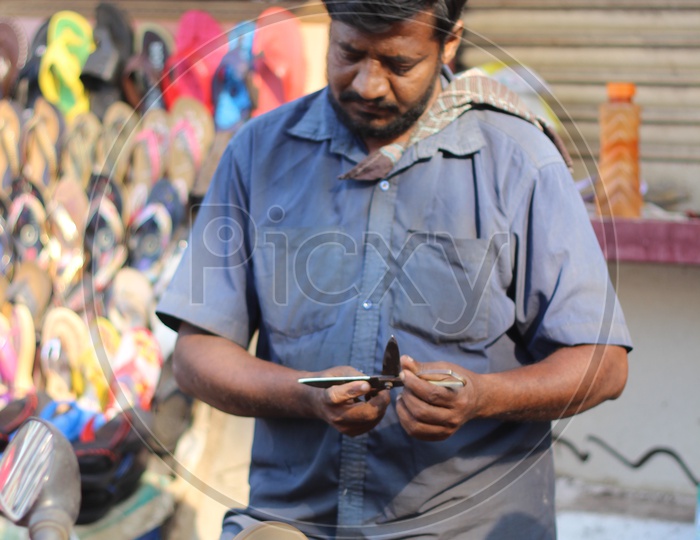 man sharpening knife In Vijayawada streets
