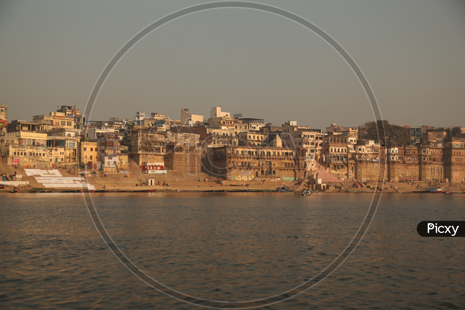 Long view of Varanasi Ghats with boats and visitors