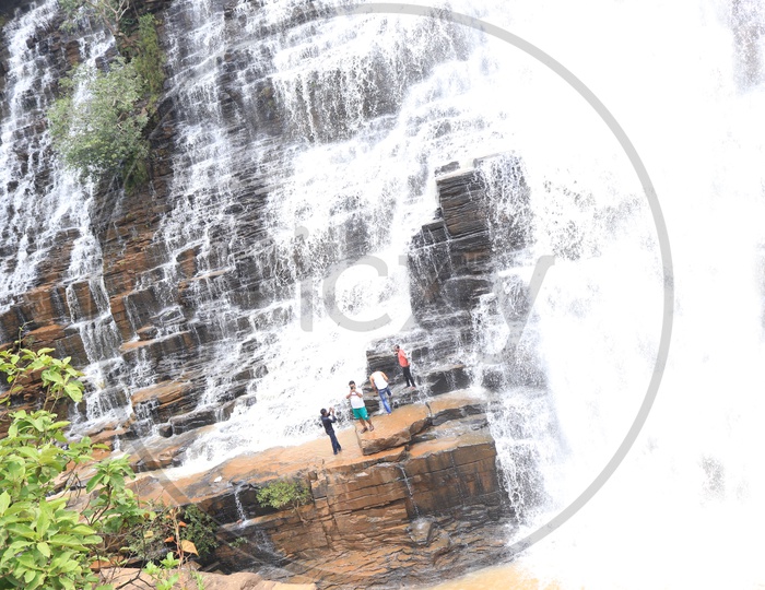 People enjoying near a waterfall