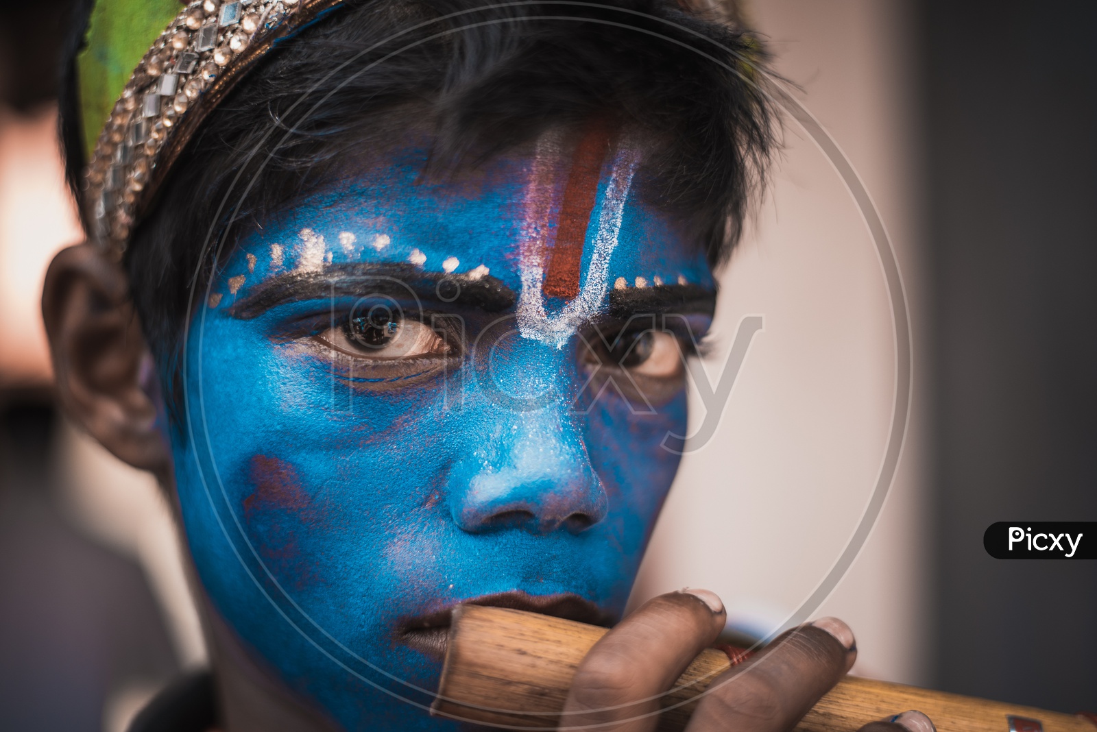 A boy wearing krishna makeup