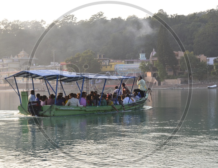 people traveling in boat in Haridwar