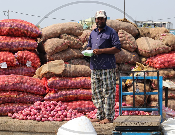 A man selling onions in a market