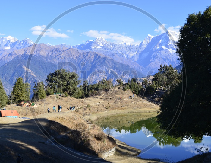 snow-capped mountains of Chopta with lake in the foreground