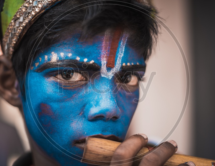 A boy wearing krishna makeup