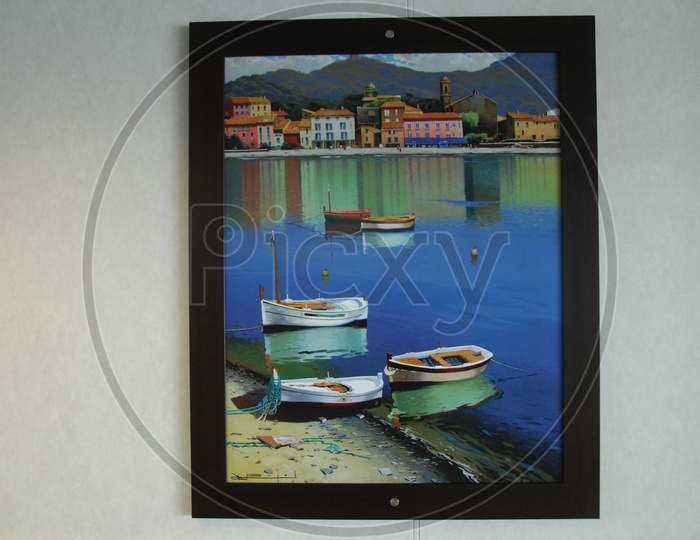 A photo frame of a painting of boats