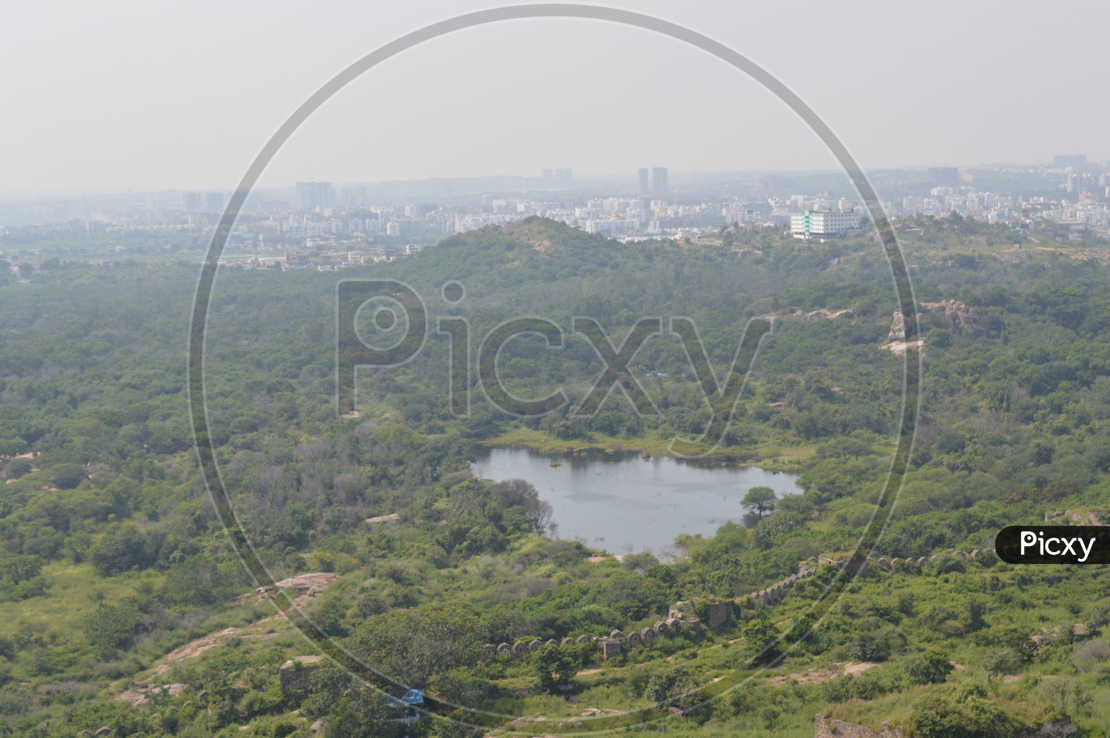 View of a pond and surrounding trees of Hyderabad city from Golconda