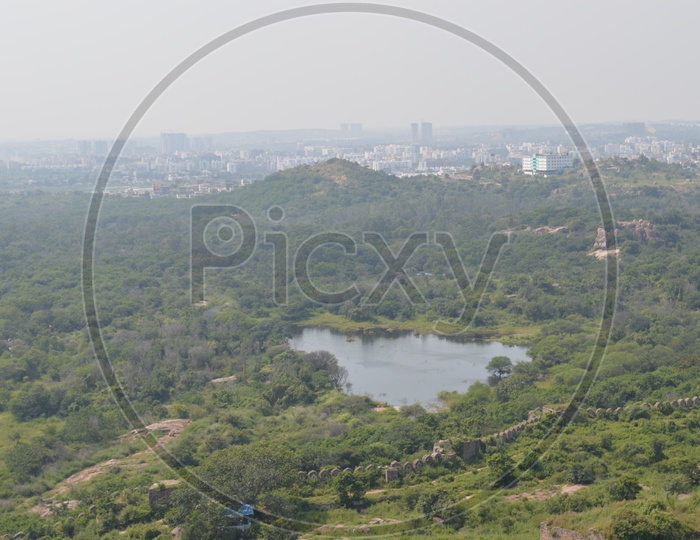 View of a pond and surrounding trees of Hyderabad city from Golconda