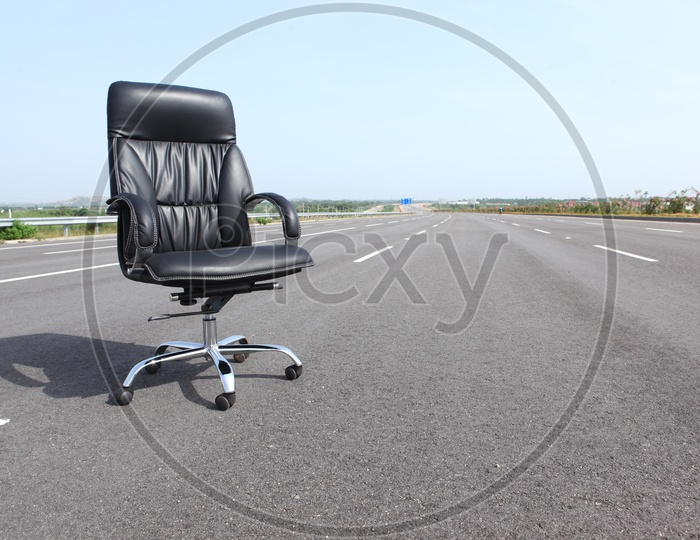 An Office Chair With Cushion on a Road