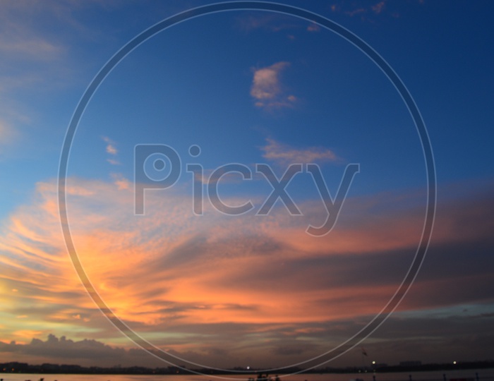 beautiful sunset sky with Hussain sagar lake in the foreground