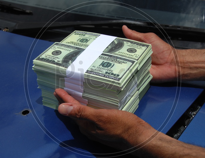 American Currency Bundles held in a Hand